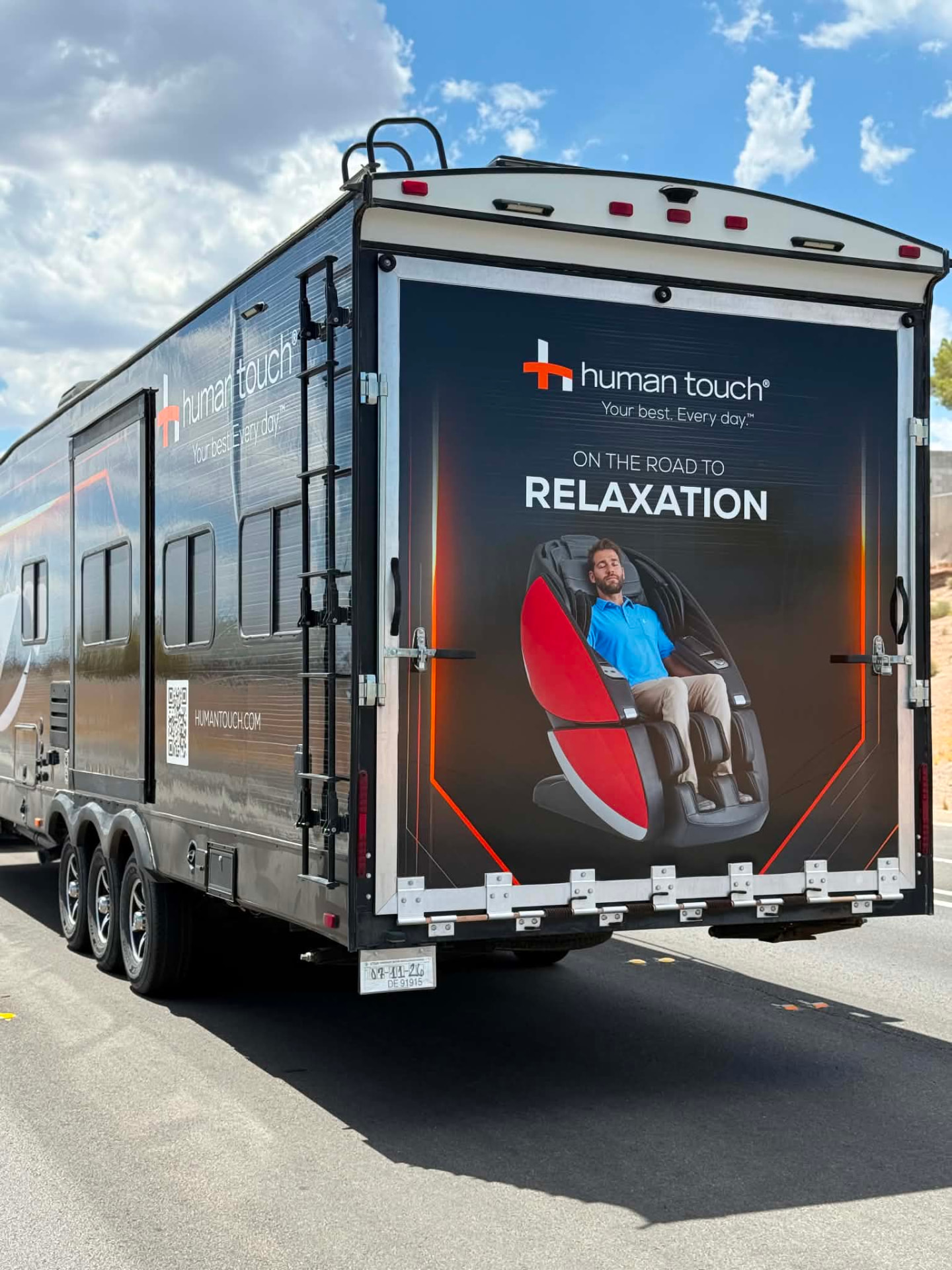Rear view of the mobile massage lounge on the road