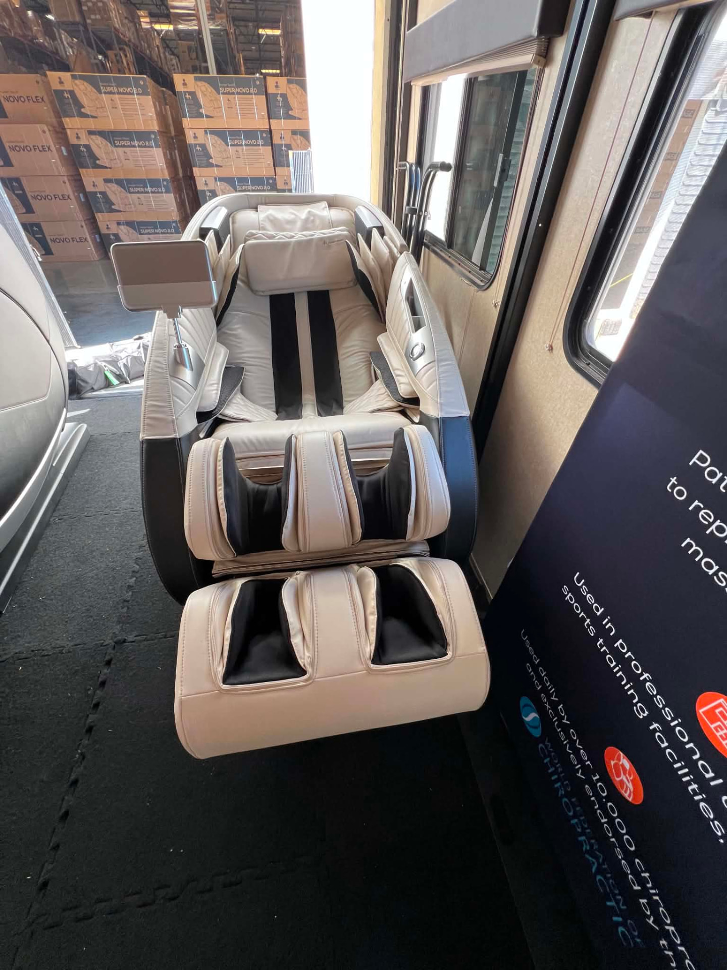 Premium full-body massage chair inside the Recharge, Relax, Recover mobile lounge